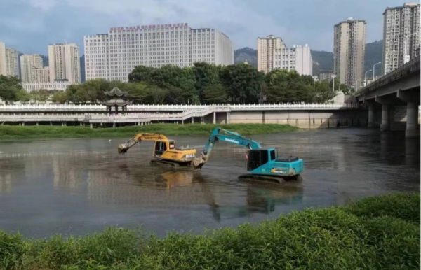 大型設(shè)備在河道中進(jìn)行清淤除草和河道整治。王春攝